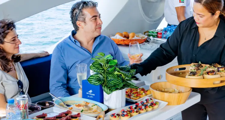 Visitors enjoying a dining cruise package on a Dubai yacht